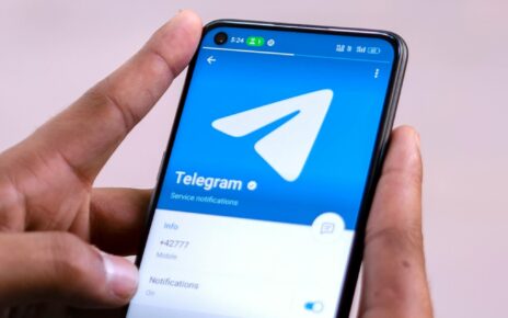 Telegram app logo on a smartphone screen, with a background highlighting concerns over criminal activities and the recent arrest of CEO Pavel Durov.